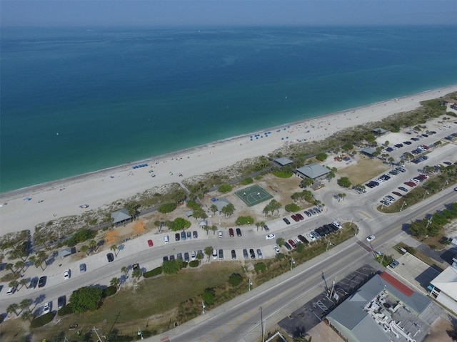 drone / aerial view with a beach view and a water view