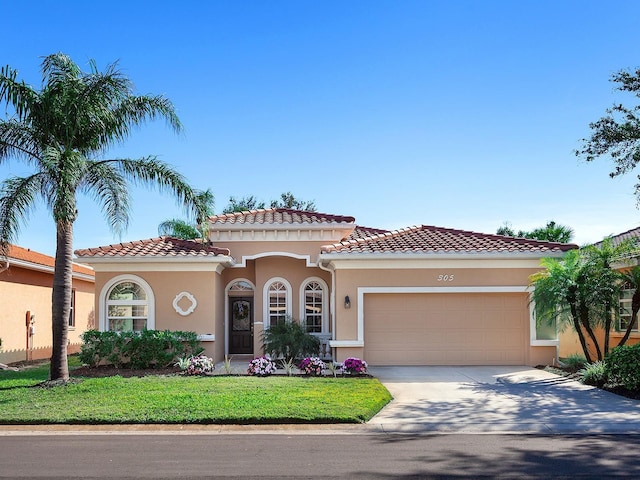 mediterranean / spanish-style house featuring a garage and a front yard