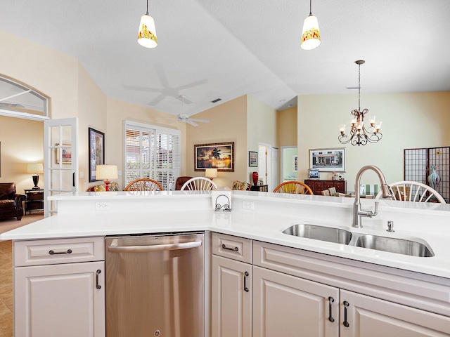 kitchen with dishwasher, sink, vaulted ceiling, white cabinets, and ceiling fan with notable chandelier