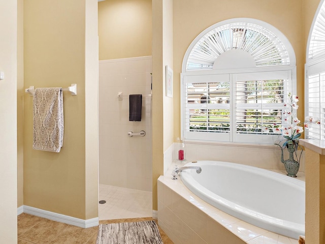 bathroom featuring tile patterned flooring and separate shower and tub