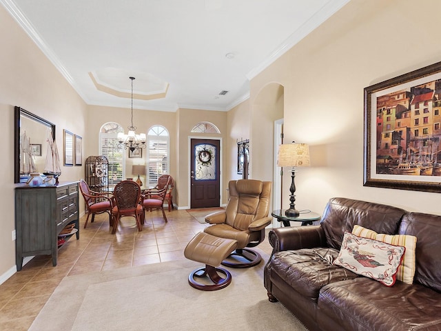 living room with a tray ceiling, an inviting chandelier, crown molding, and light tile patterned flooring