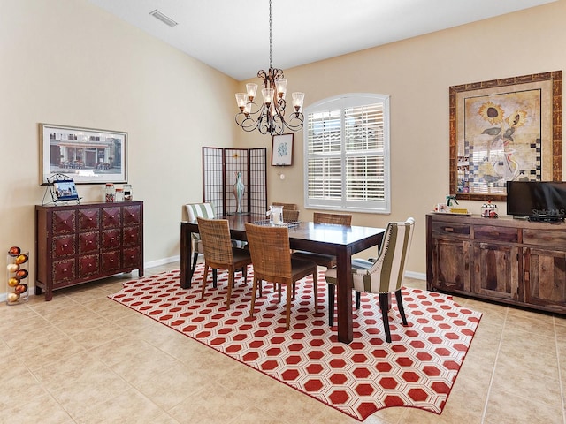 tiled dining space featuring an inviting chandelier