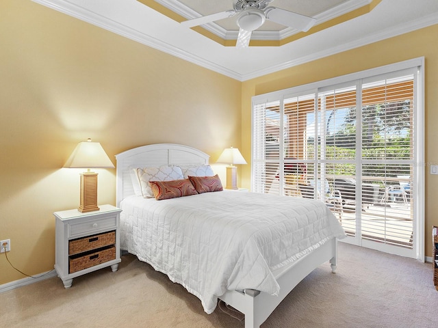 bedroom featuring ceiling fan, access to exterior, ornamental molding, a tray ceiling, and light colored carpet