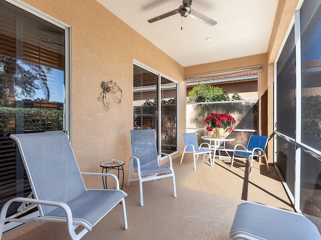 sunroom / solarium with ceiling fan and vaulted ceiling