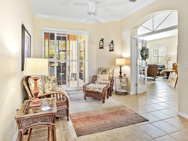 sitting room featuring crown molding, ceiling fan, and light tile patterned flooring