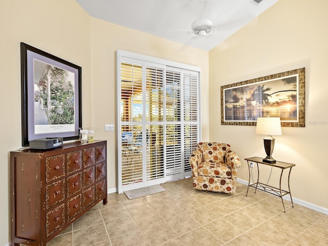 living area featuring light tile patterned floors, a wealth of natural light, and ceiling fan