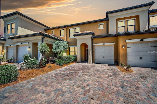 mediterranean / spanish home featuring a garage