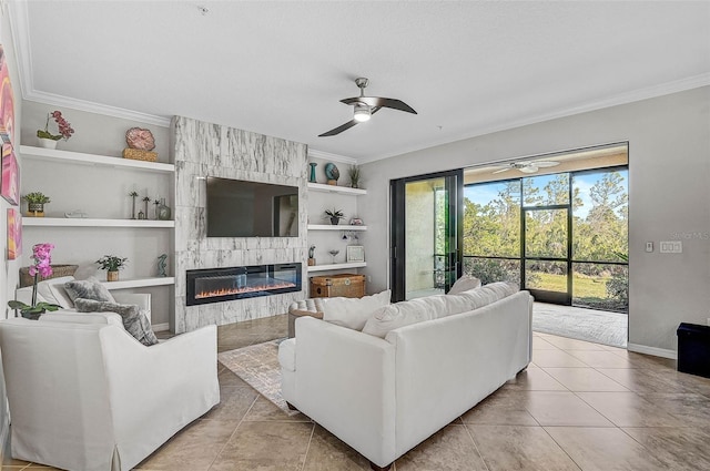 living room with ceiling fan, built in features, ornamental molding, light tile patterned floors, and a large fireplace