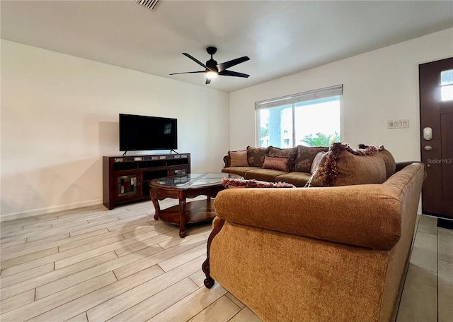 living room featuring ceiling fan and light hardwood / wood-style flooring