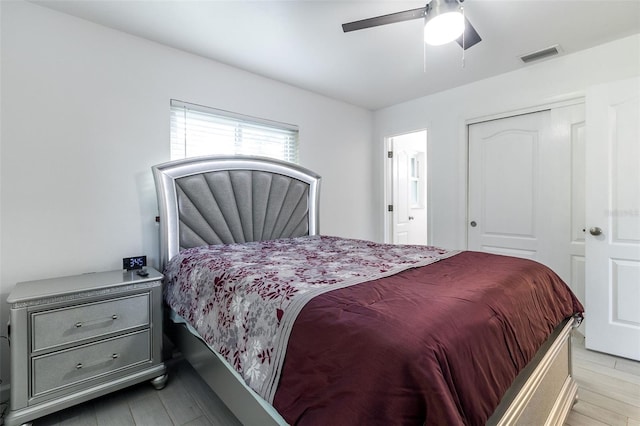 bedroom featuring light hardwood / wood-style floors, a closet, and ceiling fan