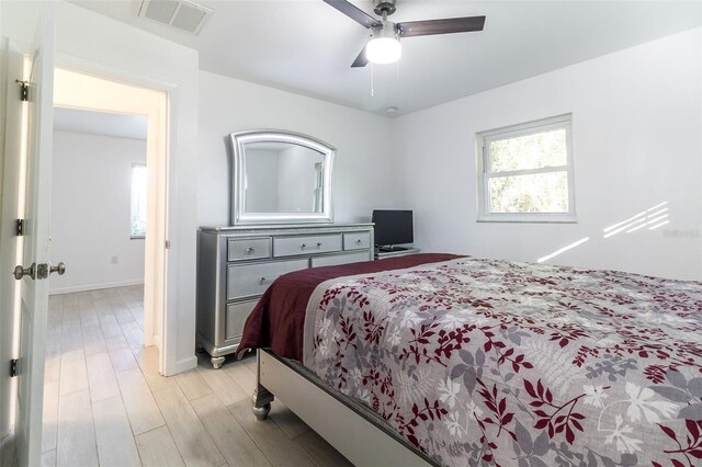 bedroom with light hardwood / wood-style flooring and ceiling fan