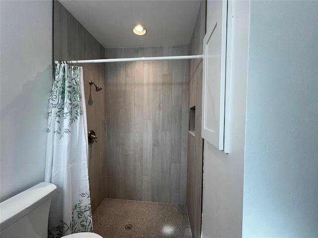 bathroom featuring toilet and walk in shower