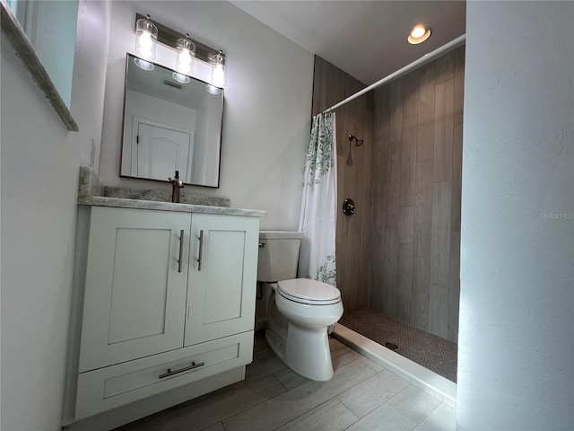 bathroom with vanity, toilet, and walk in shower