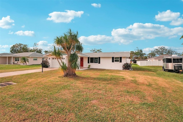 ranch-style house featuring a garage and a front yard