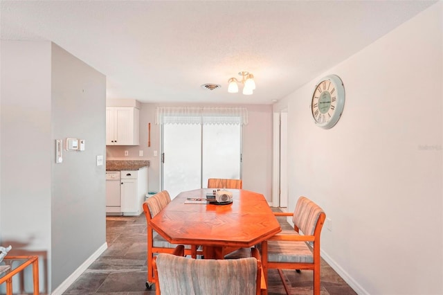 dining room featuring a textured ceiling