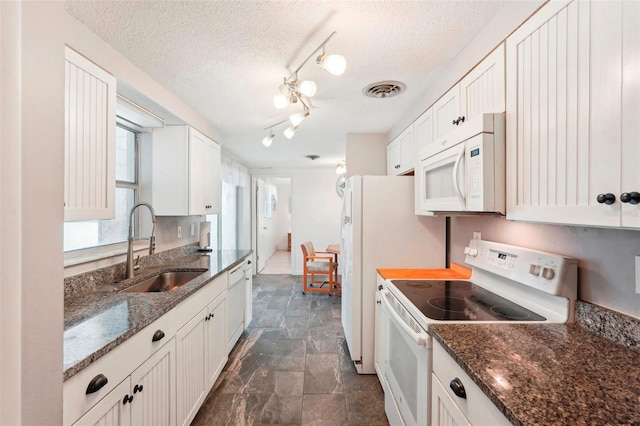 kitchen featuring white cabinets, a textured ceiling, white appliances, and sink