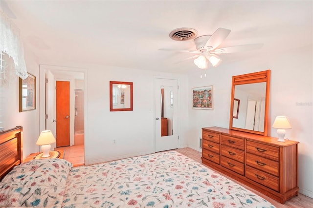 bedroom featuring connected bathroom, ceiling fan, and light hardwood / wood-style flooring