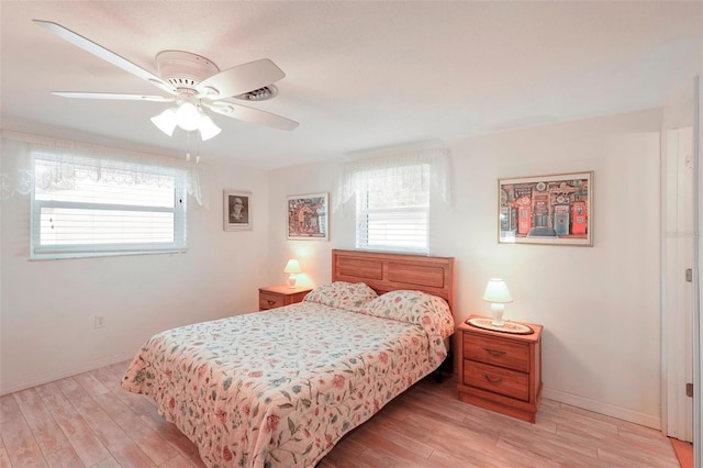 bedroom with ceiling fan and light hardwood / wood-style flooring