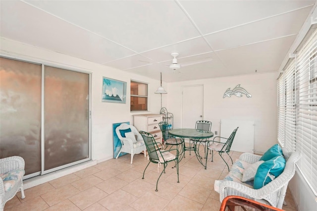 dining area featuring light tile patterned floors and ceiling fan