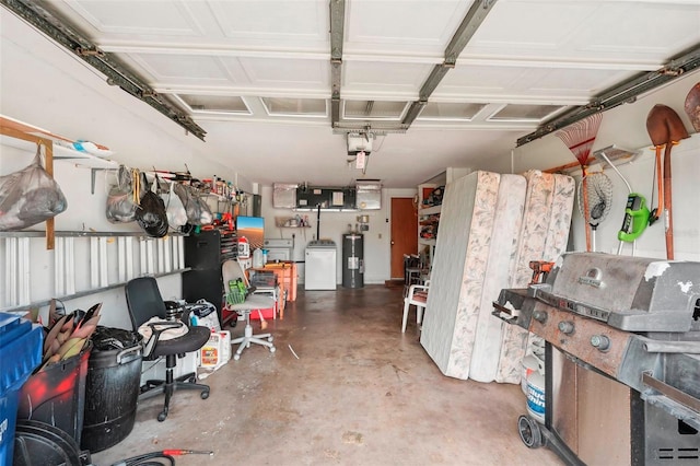 garage featuring electric water heater, a garage door opener, and washer and clothes dryer