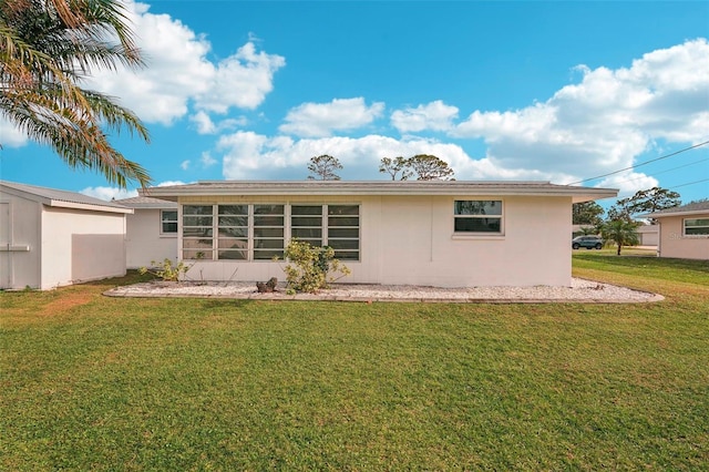 rear view of property featuring a yard