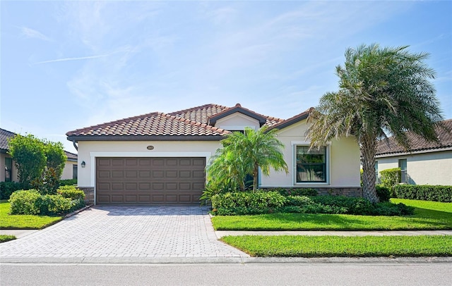 mediterranean / spanish-style house with a garage and a front yard