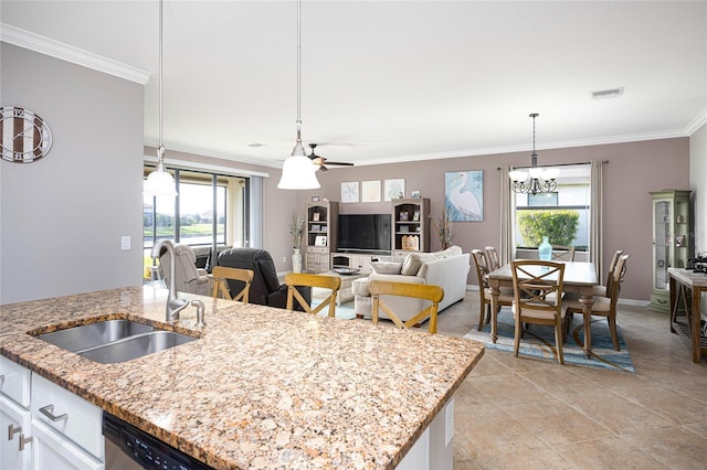 kitchen with white cabinets, light stone countertops, sink, and ornamental molding