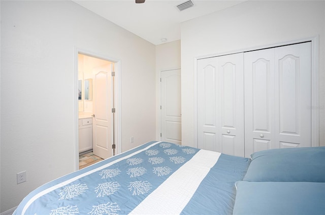 bedroom with ensuite bathroom, a closet, and ceiling fan