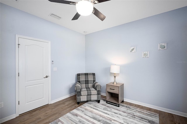 sitting room featuring hardwood / wood-style flooring and ceiling fan