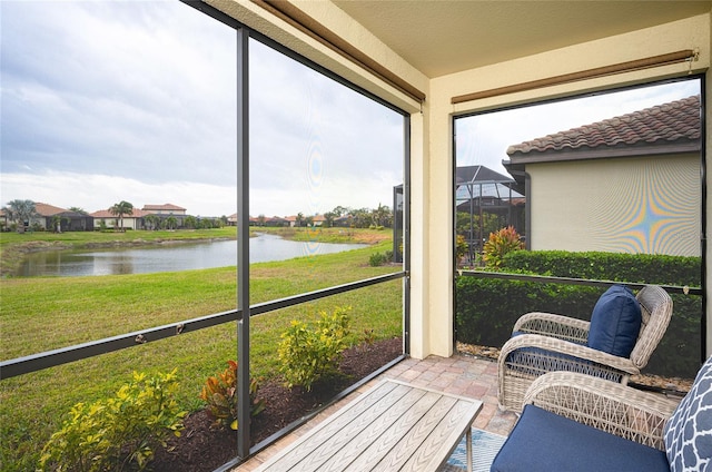 sunroom / solarium with a water view