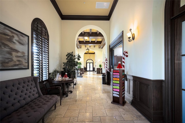 interior space featuring beam ceiling and ornamental molding