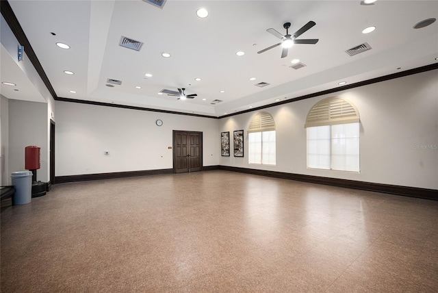 spare room featuring ceiling fan, crown molding, and a tray ceiling