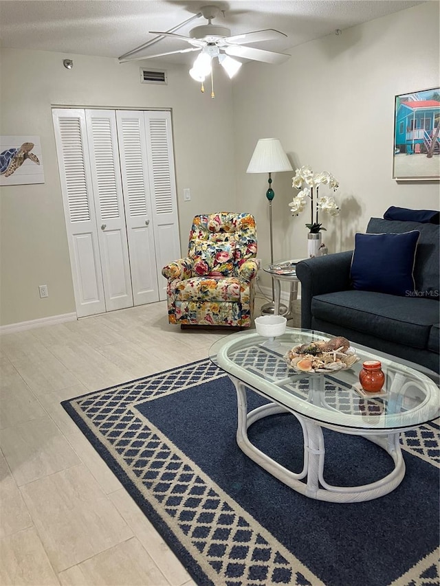 living room with ceiling fan and hardwood / wood-style flooring