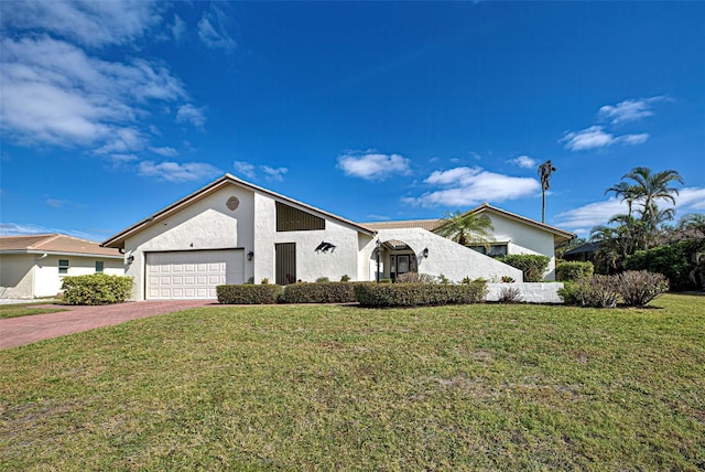 view of front of house featuring a front yard and a garage