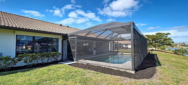 view of swimming pool featuring a yard and a lanai