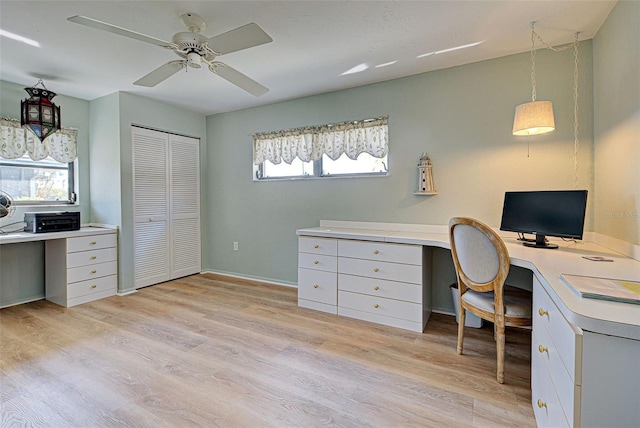 home office featuring light hardwood / wood-style flooring, ceiling fan, and a healthy amount of sunlight