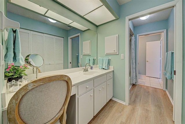 bathroom with hardwood / wood-style floors and vanity