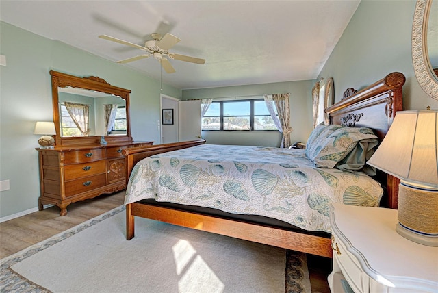 bedroom with ceiling fan and wood-type flooring