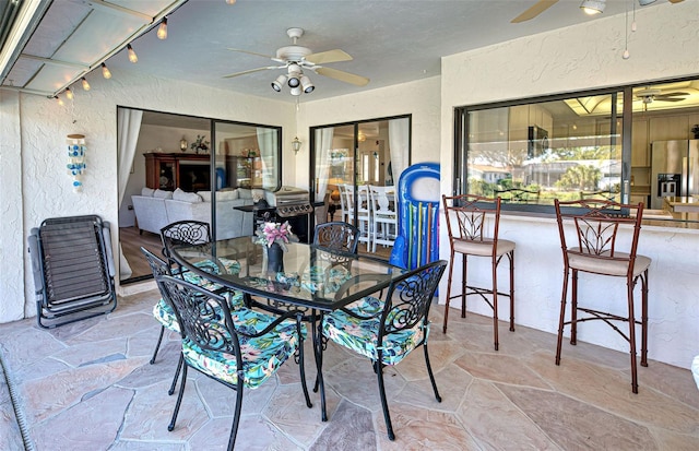 interior space with ceiling fan and a grill