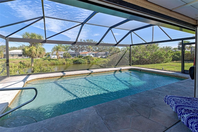 view of swimming pool with glass enclosure, a patio area, and a water view