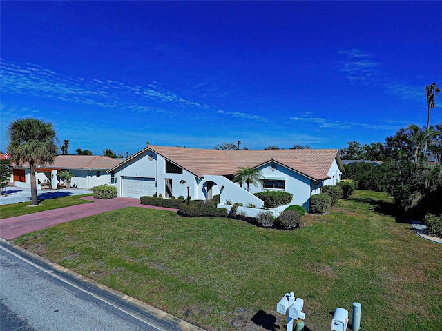 ranch-style house with a front yard and a garage