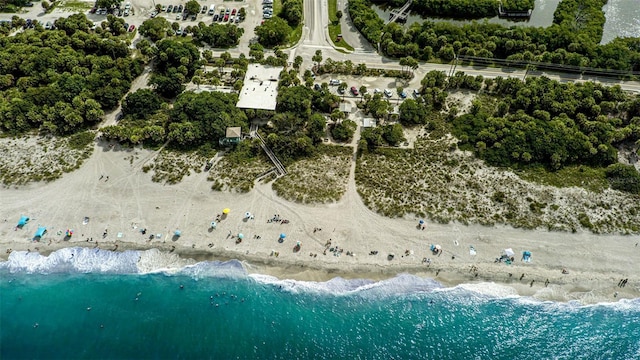 drone / aerial view with a water view and a view of the beach