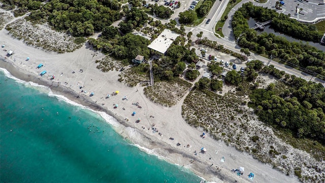 birds eye view of property featuring a water view and a view of the beach