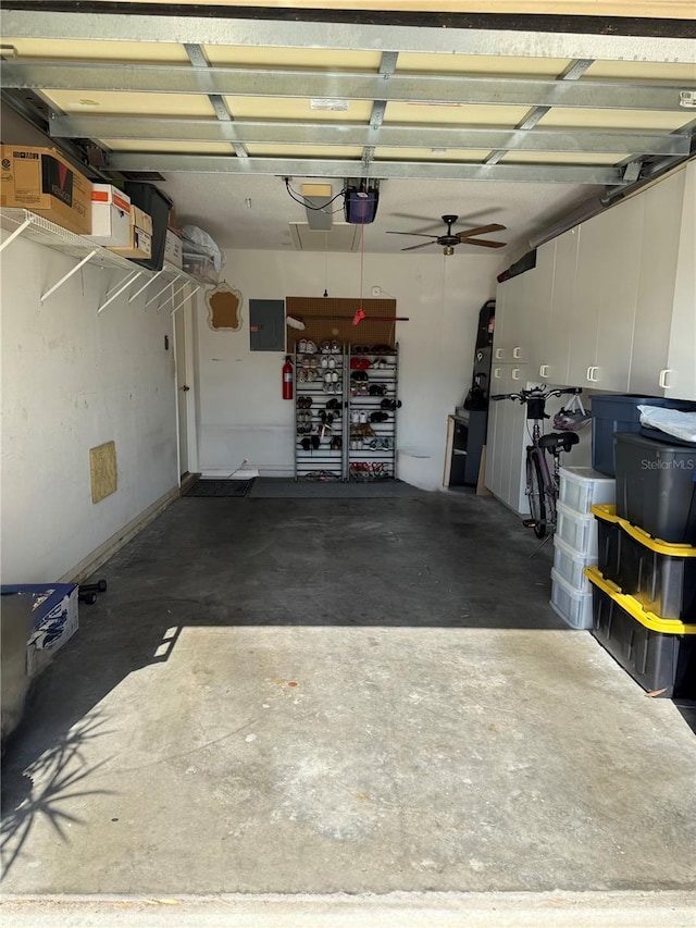 garage with ceiling fan, a garage door opener, and electric panel