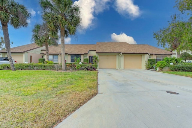 single story home with a front yard and a garage