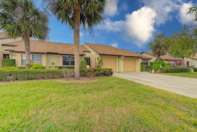 single story home featuring a garage and a front lawn