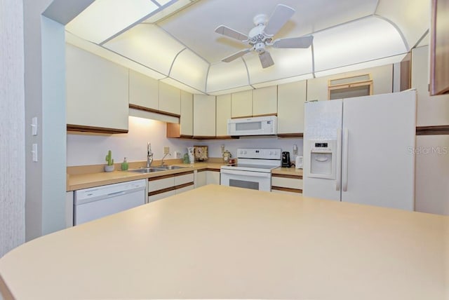 kitchen featuring ceiling fan, sink, white appliances, and cream cabinetry