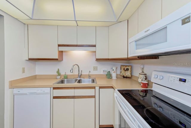 kitchen featuring white cabinets, white appliances, and sink