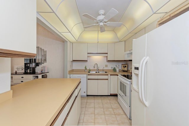 kitchen with white appliances, ceiling fan, sink, light tile patterned floors, and white cabinetry