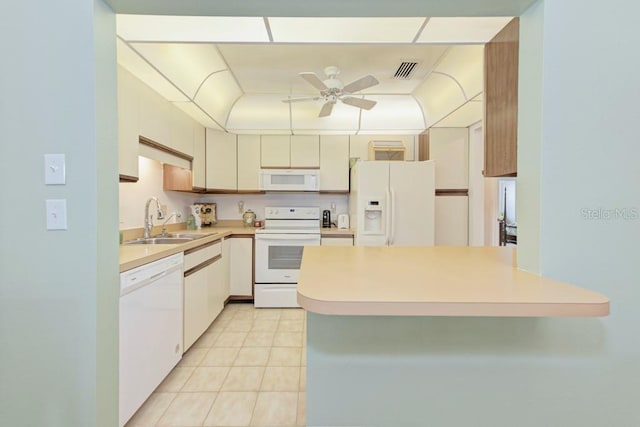 kitchen with white appliances, ceiling fan, sink, light tile patterned floors, and cream cabinets